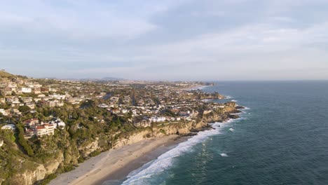 Dramatic-aerial-drone-shot-of-Orange-County,-California-Coast-on-a-cloudy-day