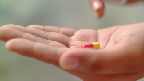 close-up-hand-received-one-drug-capsule