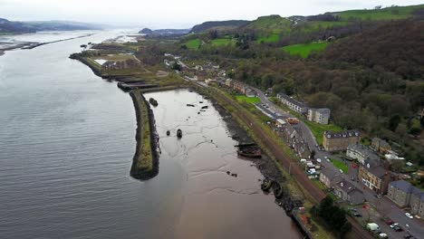 Aerial-Fly-Over-Of-A-Stranded-Boat-Wreckage-In-Sand-At-Bowling-Harbour-in-West-Dunbartonshire-Scotland
