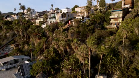 Aerial-drone-shot-of-coastal-real-estate-among-palm-trees-in-Orange-County---California