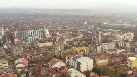 Aerial-flyover-shot-the-city-of-Kraljevo,-Serbia-on-an-overcast-day