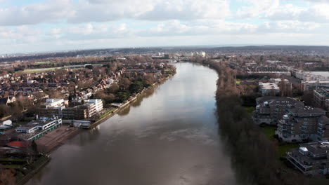 Dolly-forward-drone-shot-over-thames-river-towards-chiswick-bridge-west-London