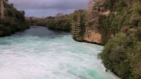 Swirling-body-of-water-at-the-end-of-Huka-Falls-in-the-Wairakei-Tourist-Park,-slow-motion