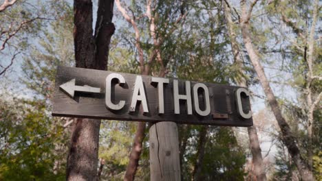 Wooden-Cemetery-Sign-Pointing-To-Catholic-Section-of-Graveyard---4K