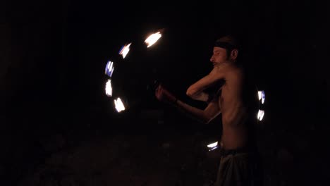 A-young-male-performer-dances-with-a-fire-fan