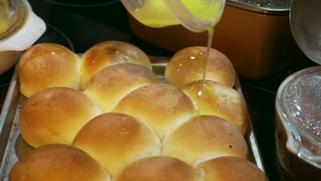 Hot-butter-being-poured-over-fresh-baked-rolls