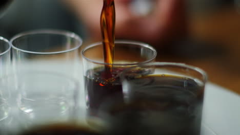 Jägermeister-being-poured-in-slow-motion-into-a-row-of-shot-glasses