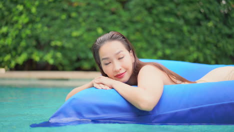 Beautiful-Asian-Woman-Relaxing-on-Inflatable-Air-Pool-Lounge-Mattress