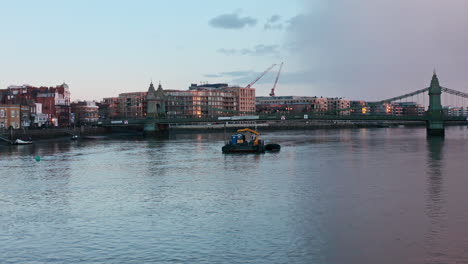 Low-drone-shot-over-river-thames-and-Hammersmith-bridge-evening