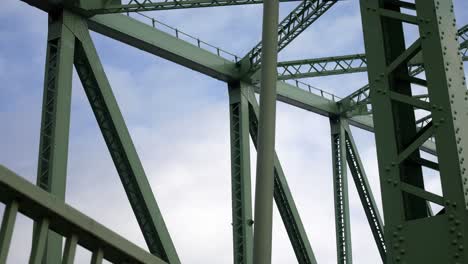 Industrial-steel-bridge-strong-girder-beam-support-framework-blue-sky-slow-dolly-right