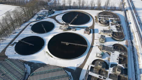 Stunning-aerial-of-water-basins-at-sewage-treatment-plant-in-winter