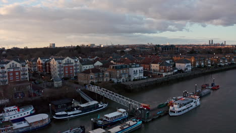 rising-dolly-forward-drone-shot-over-chiswick-pier-west-London-at-sunset