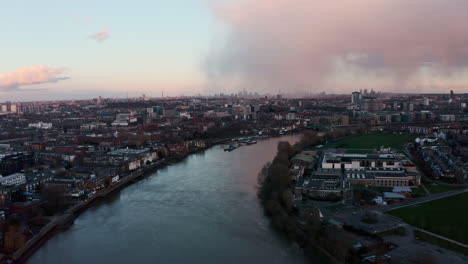 Drone-shot-over-river-thames-towards-hammersmith-central-London-sunset