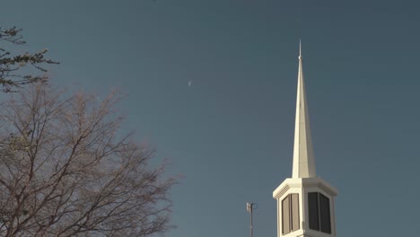Latter-Day-Saints-Mormon-Church-Spire-during-Sunrise-with-Half-Moon-still-Visible-in-Sky-4K