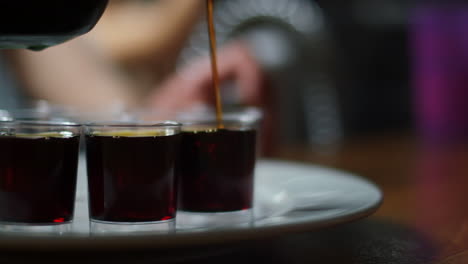 The-last-shot-of-Jägermeister-on-a-tray-of-shots-being-filled-in-slow-motion