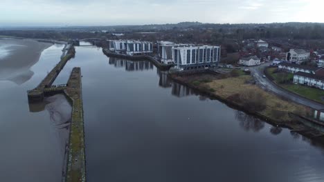 Early-morning-aerial-descending-view-riverside-waterfront-contemporary-apartment-office-buildings-canal-regeneration-real-estate