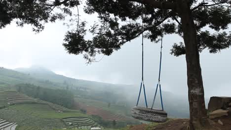 one-swing-atop-a-hill-that-moves-without-people