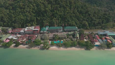 An-empty-coastal-beach-development-with-hotel-and-resorts-in-Koh-Chang,-Thailand