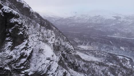 Mountain-Ridges-parallax-slowly-in-northern-landscape-of-the-Scandinavian-mountain-Range---Aerial-slide-crane-down