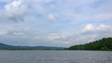 A-beautiful-lake-in-the-wilderness-with-a-sky-full-of-puffy-clouds