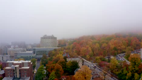 Aerial-shot-of-a-misty-Montreal-morning-in-fall,-pan-from-the-mountain-to-the-downtown-skyline