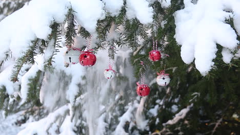 Spruce-snow-covered,-Christmas-tree-decor,-bauble-red-and-white,-fluffy-snowfall