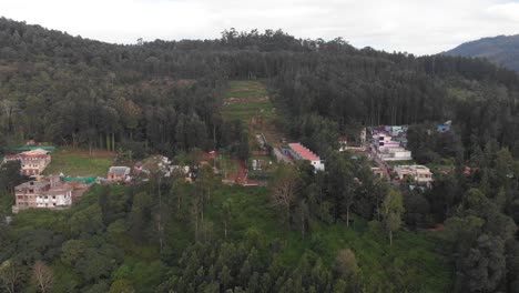Aerial-view-of-a-Small-Indian-village-suburb-in-a-natural-forest-environment-on-a-cloudy-day,-travel-concept