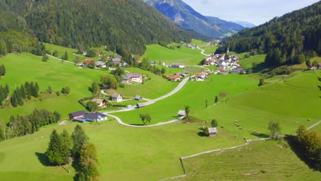 A-drone-shot-of-a-small-town-with-houses-and-a-valley-at,-Austria