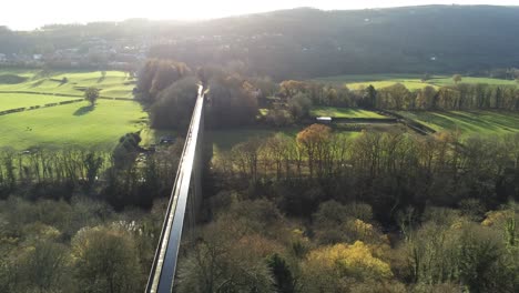 Old-Welsh-Pontcysyllte-Aqueduct-waterway-aerial-view-rural-Autumn-woodlands-valley-forward-orbit-right