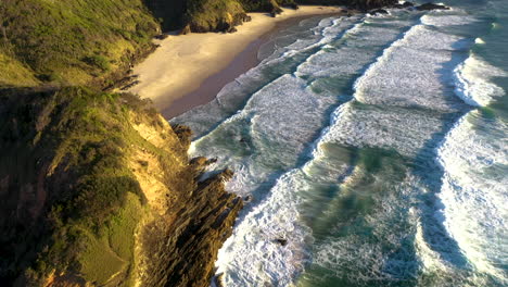 Epic-drone-shot-starting-on-crashing-waves-then-revealing-coastline-at-Broken-Head-coast-near-Byron-Bay