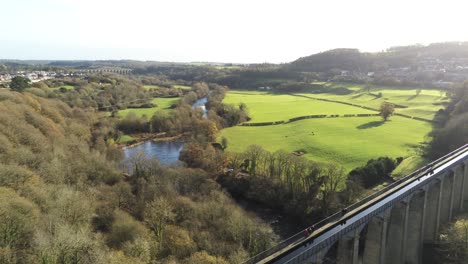 Old-Welsh-Pontcysyllte-Aqueduct-waterway-aerial-view-rural-Autumn-woodlands-valley-rising-dolly-right