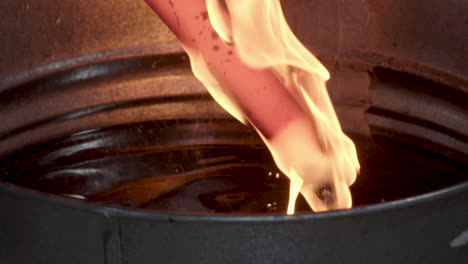 Blacksmith-Pulling-Burning-Blade-From-Hot-Oil