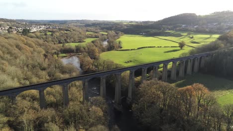 Old-Welsh-Pontcysyllte-Aqueduct-waterway-aerial-view-rural-Autumn-woodlands-valley-descending-left