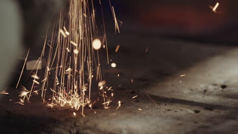 Metal-Cutting-Sparks-On-An-Old-Wooden-Workbench