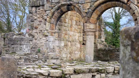 Ancient-Basingwerk-abbey-abandoned-historical-landmark-arched-architecture-building-stone-walls-dolly-left