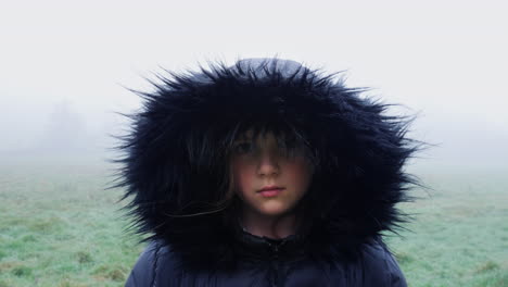 portrait-of-a-hooded-girl-on-a-cold-misty-morning-in-the-countryside