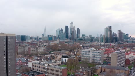 Aerial-dolly-back-shot-over-residential-area-to-central-London-skyscrapers