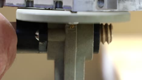 Close-up-of-removing-wooden-dowel-from-jig-after-making-bolt-threads-on-dowel