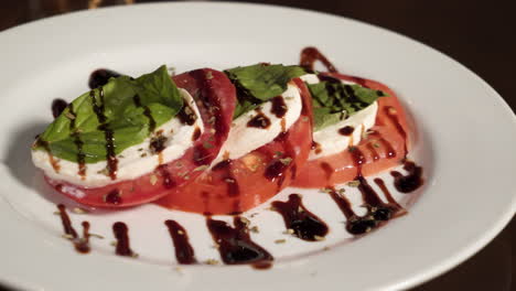 Caprese-salad-dressed-with-balsamic-drizzle,-tomato-mozzarella-basil-salad,-slider-4K