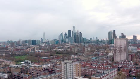 Aerial-circling-slider-shot-over-residential-area-to-central-London-skyscrapers