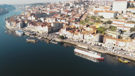 Porto-old-town-riverbank-'Ribeira'---Wide-Aerial-descending-shot