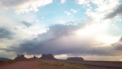 Panning-shot-from-sun-peeking-through-clouds-to-Monument-Valley