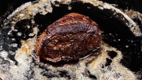 Steak-cooking-in-butter-on-cast-iron-skillet