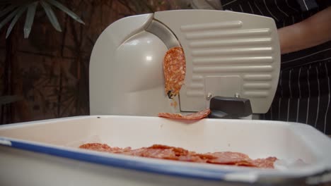 Koch-Schneidet-Salami-Auf-Einer-Fleischschneidemaschine