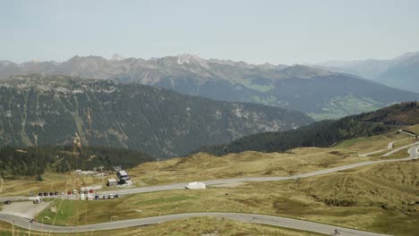 Wide-shot-of-scenic-road-with-alps-in-background