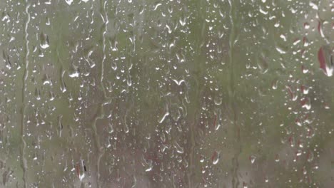 Regenstreifen-Und-Wassertröpfchen-Auf-Fenster-Mit-Verschwommenem-Grünem-Hintergrund