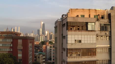 Reveal-of-Guangzhou-city-downtown-CBD-area-from-behind-old-buildings