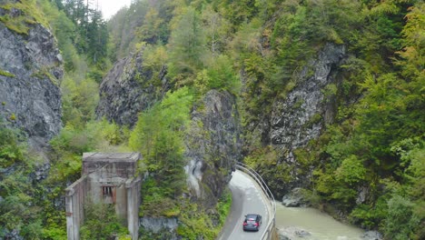 Aerial-Follow-Shot-Of-Car-Driving-Along-Winding-Road-In-Eisenkappel-Vellach,-Austria