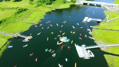 Paddlers-preparing-for-a-kayak-race---as-seen-via-drone-on-a-bright-sunny-day