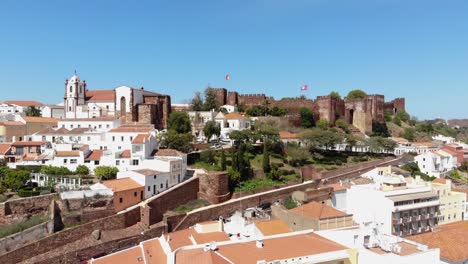 Scenic-aerial-view-of-fortified-and-walled-city-and-Castle-of-Silves,-Algarve,-Portugal